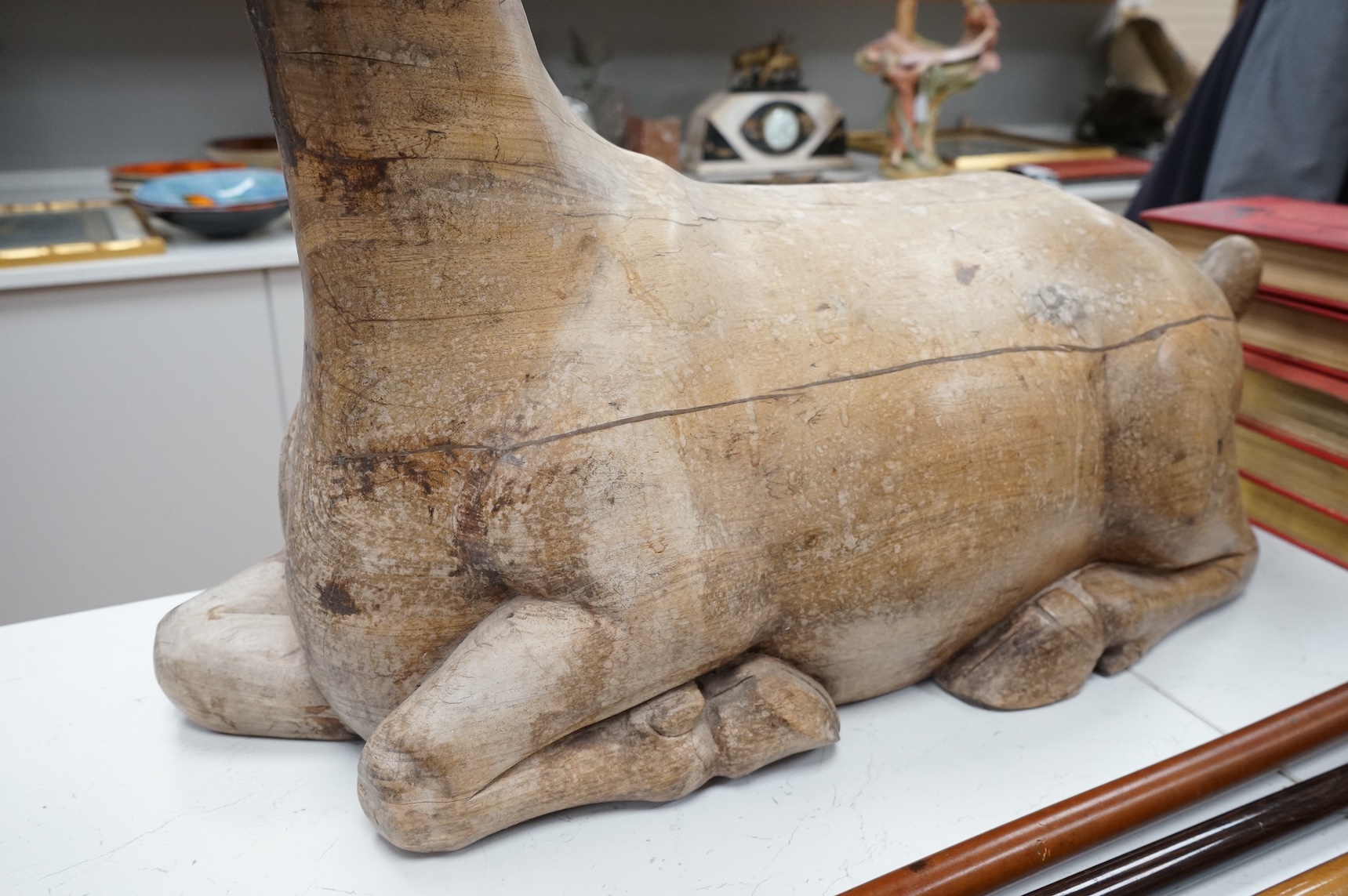 A large Vietnamese hardwood model of a recumbent goat, 78cm wide